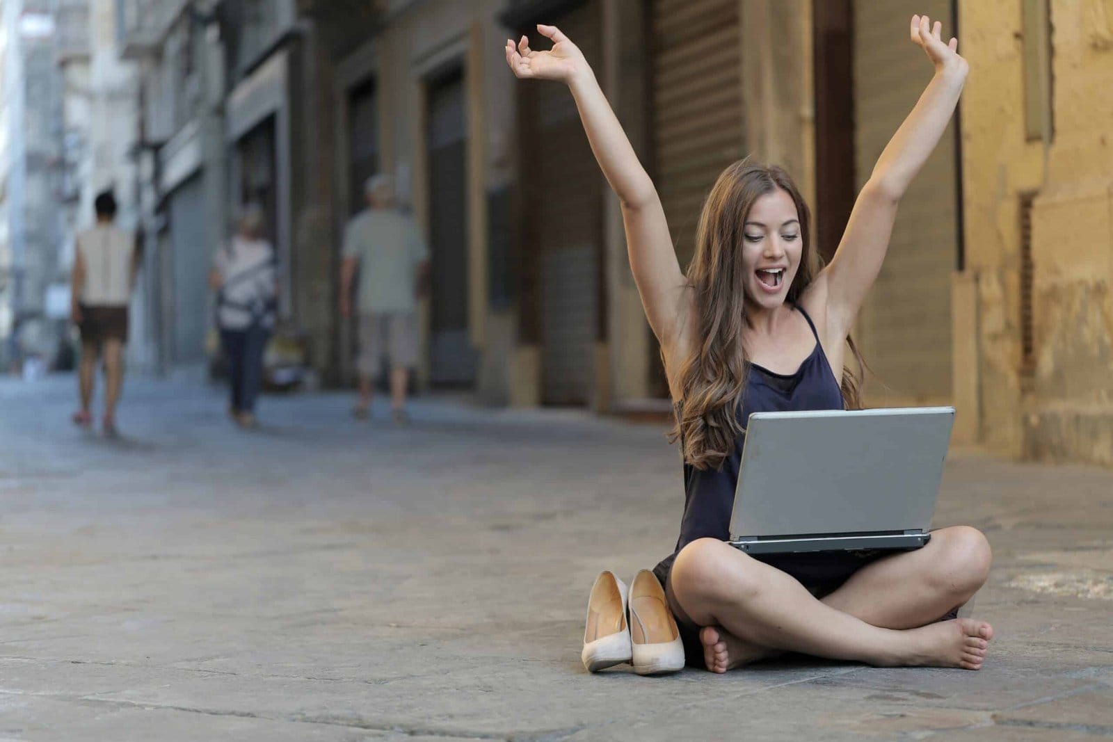 Digital Nomad Sitting on a street floor with a laptop